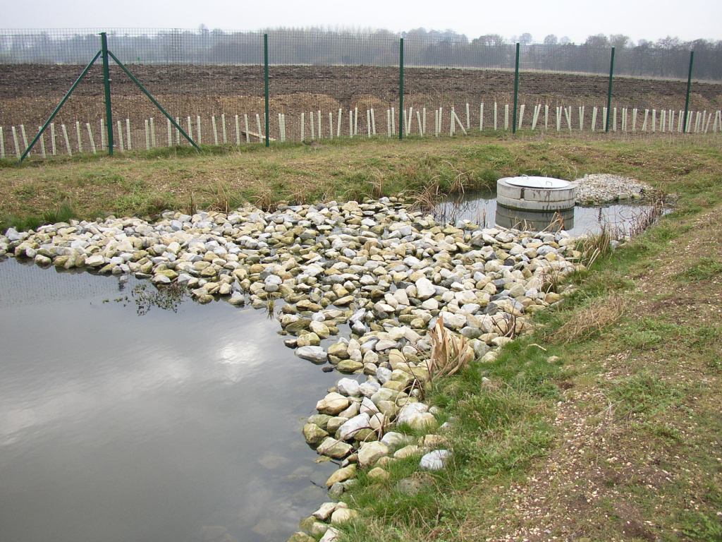 Rock filter around fac. pond outlet